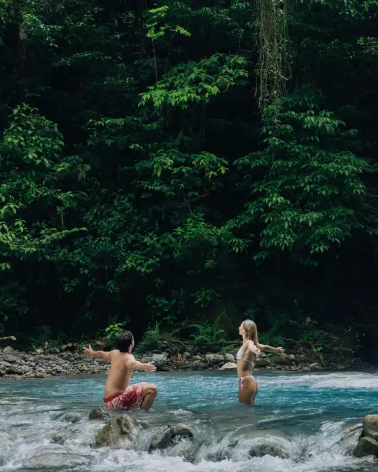 Couple enjoying a rainforest river cascade at Sensoria, Costa Rica