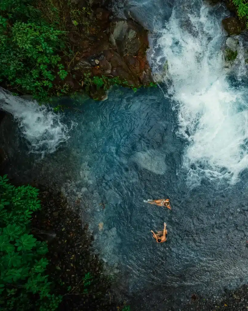 Aerial view of swimmers in a turquoise pool at Sensoria, Rincón de la Vieja