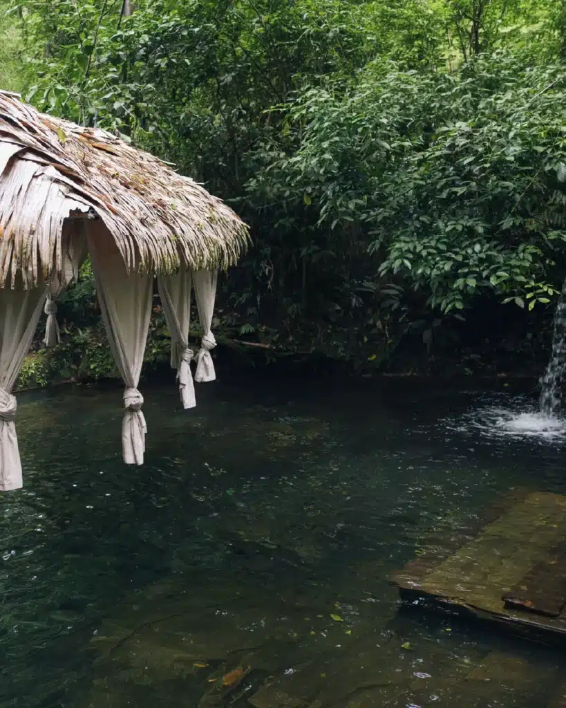 Thatched lounge beside a private rainforest pool at Sensoria